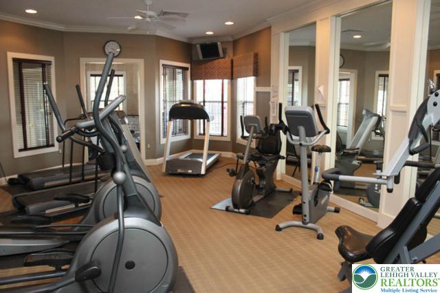 gym with carpet floors, a ceiling fan, baseboards, recessed lighting, and ornamental molding
