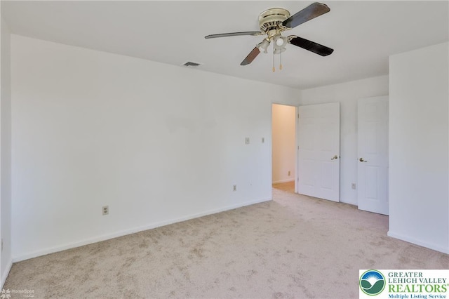 unfurnished bedroom with carpet floors, baseboards, and visible vents