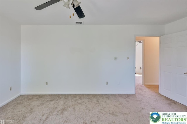 unfurnished room with baseboards, a ceiling fan, carpet flooring, and visible vents