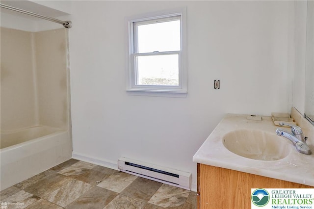 bathroom with vanity, bathtub / shower combination, and baseboard heating