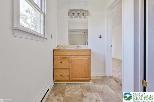 bathroom with vanity, baseboards, and stone finish floor