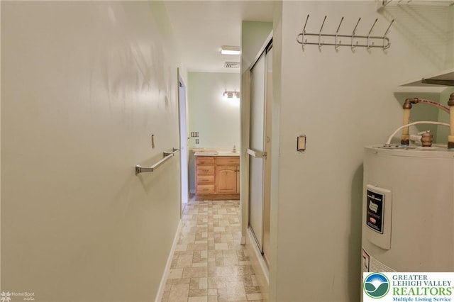 3 Dusty Rd, Palmer Twp, PA 18045 - hallway with baseboards, visible vents, stone finish floor, and electric water heater