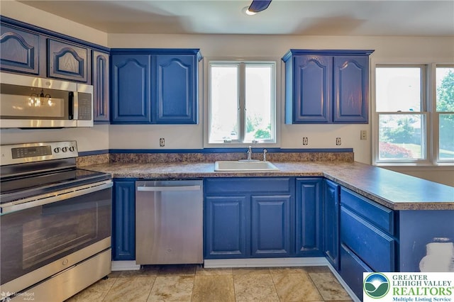 kitchen with stainless steel appliances and blue cabinetry