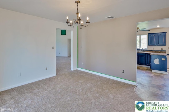 unfurnished room with an inviting chandelier, baseboards, visible vents, and light colored carpet