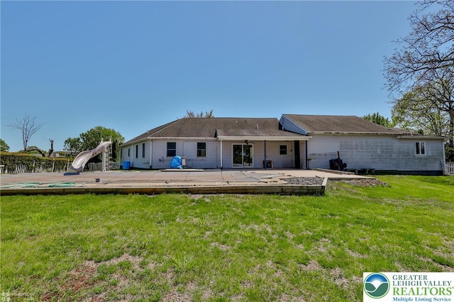 back of house featuring a patio area and a yard