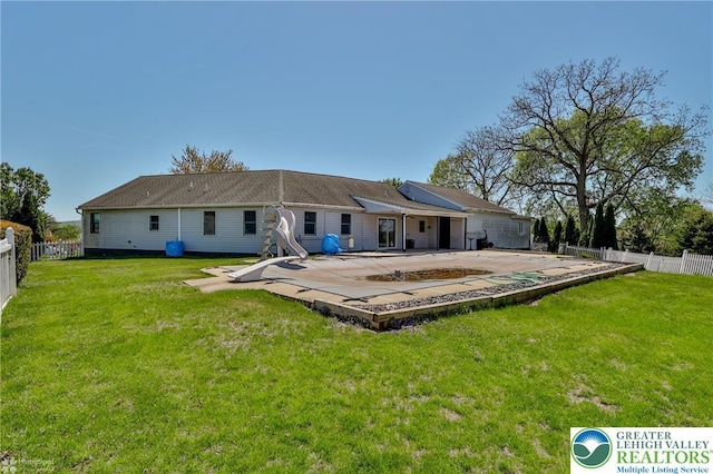 rear view of property with a yard, a patio, and a fenced backyard