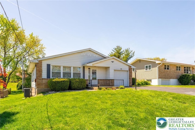 3040 Keystone St, Bethlehem Twp, PA 18020 - view of front of home featuring driveway, a front yard, brick siding, central AC, and an attached garage