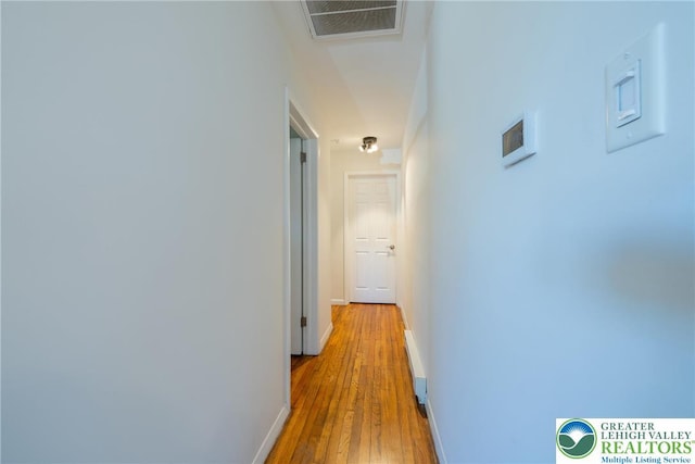 3040 Keystone St, Bethlehem Twp, PA 18020 - hallway featuring a baseboard heating unit, baseboards, visible vents, and light wood-style flooring