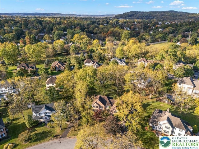 drone / aerial view with a residential view and a forest view