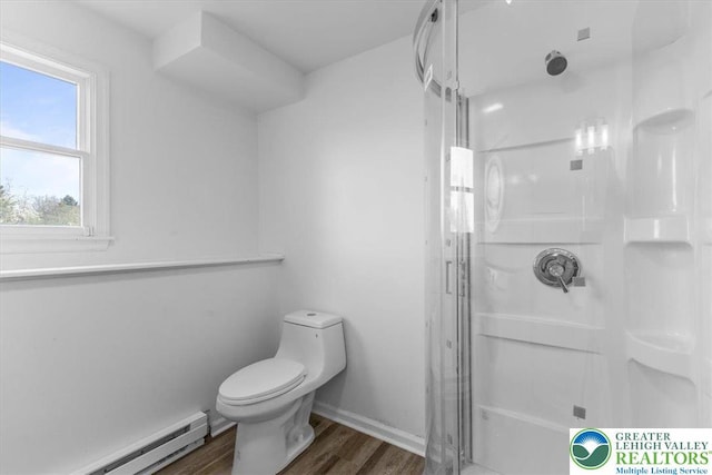 full bathroom featuring a baseboard radiator, wood finished floors, toilet, and a shower stall