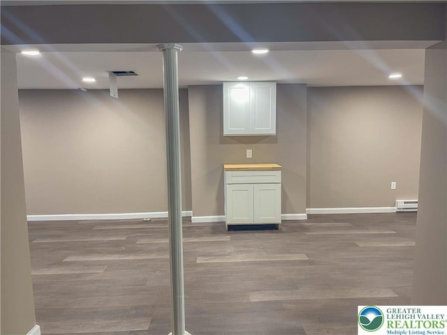 1231 Fairmount St, Bethlehem City, PA 18017 - finished basement featuring visible vents, wood finished floors, baseboards, recessed lighting, and a baseboard heating unit