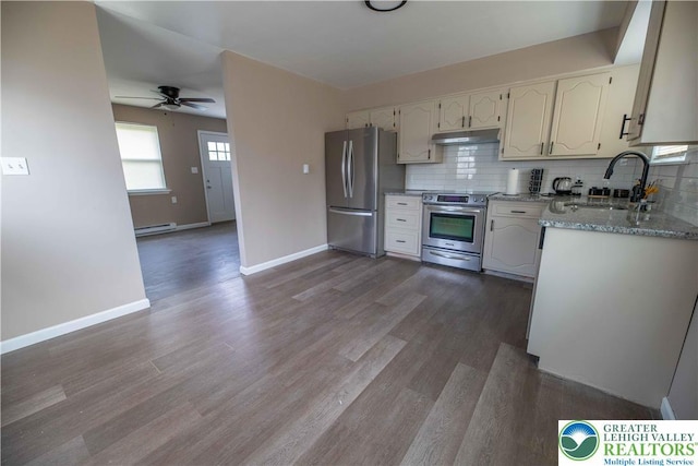 1231 Fairmount St, Bethlehem City, PA 18017 - kitchen with backsplash, appliances with stainless steel finishes, a sink, a baseboard radiator, and under cabinet range hood