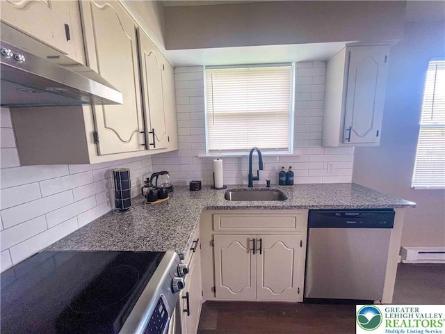 1231 Fairmount St, Bethlehem City, PA 18017 - kitchen with a healthy amount of sunlight, decorative backsplash, appliances with stainless steel finishes, a sink, and under cabinet range hood