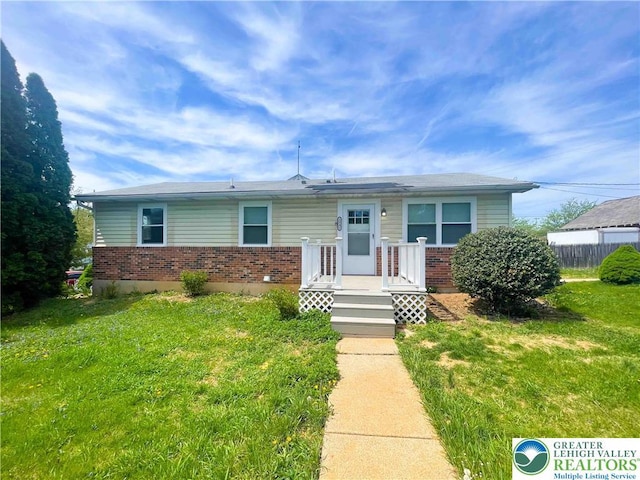 1231 Fairmount St, Bethlehem City, PA 18017 - view of front of house featuring fence, a front yard, and brick siding