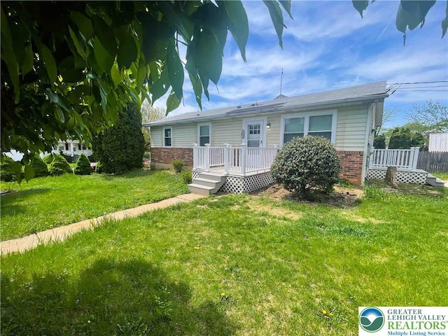 1231 Fairmount St, Bethlehem City, PA 18017 - view of front facade with brick siding, a deck, and a front lawn
