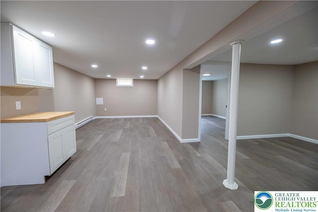 1231 Fairmount St, Bethlehem City, PA 18017 - finished below grade area with baseboards, a baseboard heating unit, recessed lighting, and light wood-style flooring
