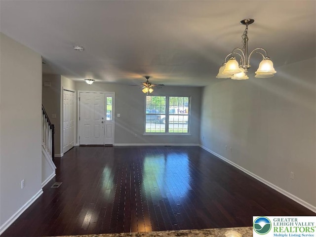 unfurnished living room with baseboards, stairs, and hardwood / wood-style floors