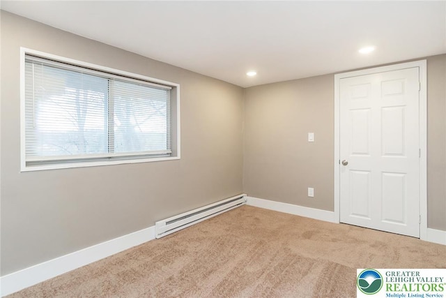 empty room featuring carpet floors, a baseboard radiator, baseboards, and recessed lighting
