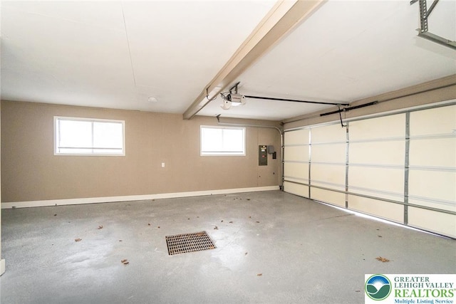 garage with baseboards, a garage door opener, and electric panel