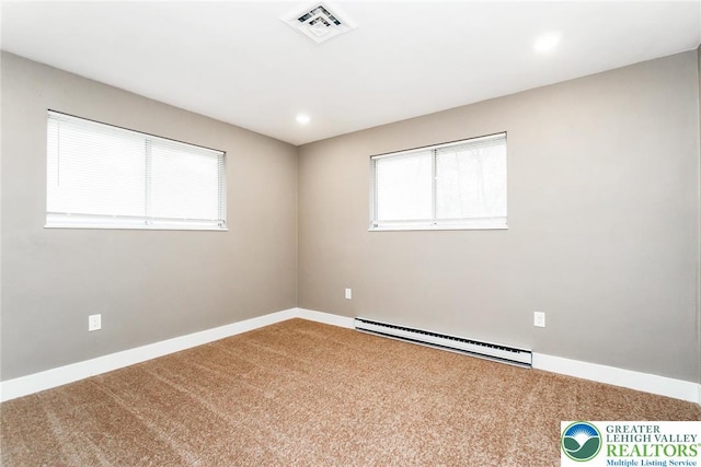 carpeted spare room featuring visible vents, a baseboard radiator, baseboards, and plenty of natural light