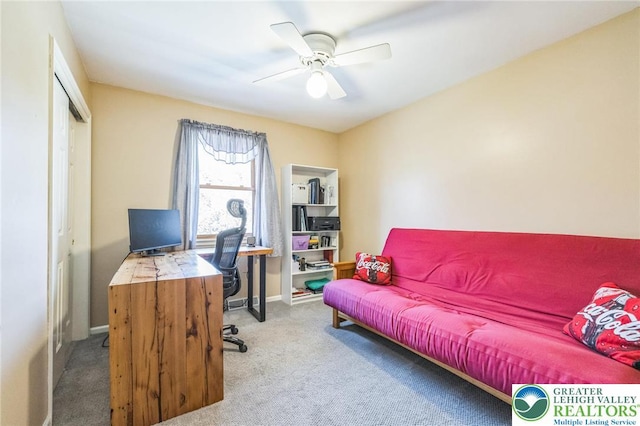 office space with baseboards, a ceiling fan, and carpet