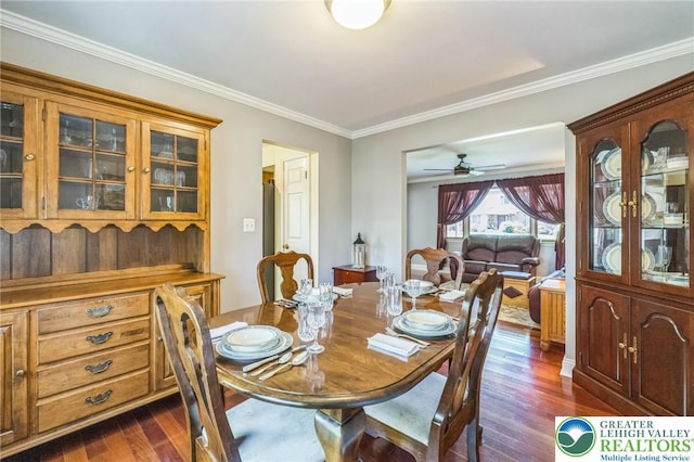 dining space featuring ceiling fan, dark wood finished floors, and ornamental molding