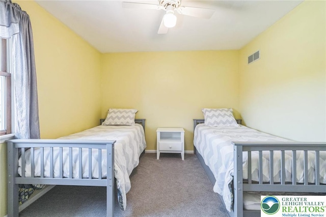 bedroom with carpet floors, baseboards, a ceiling fan, and visible vents
