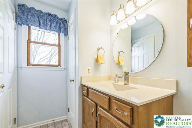 bathroom with baseboards and vanity