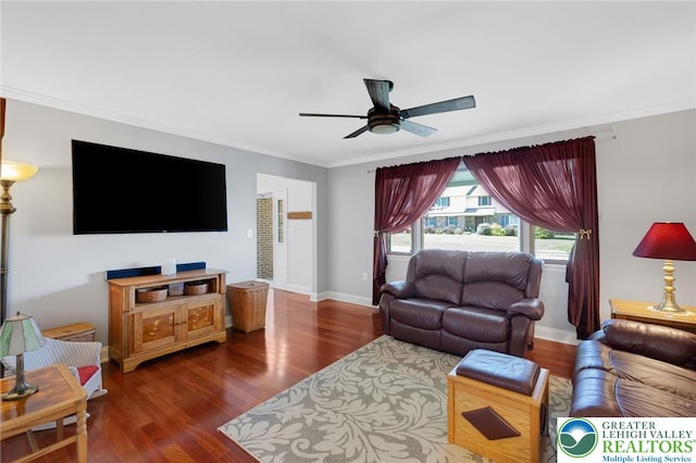 living area with baseboards, ceiling fan, ornamental molding, and wood finished floors
