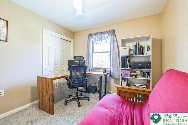 carpeted home office featuring baseboards