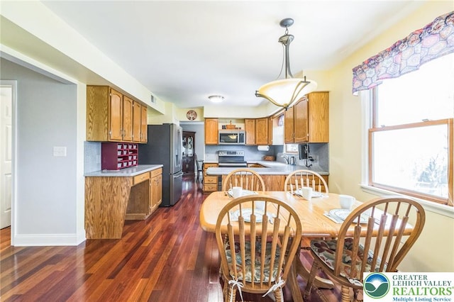 dining space with baseboards, plenty of natural light, and dark wood finished floors