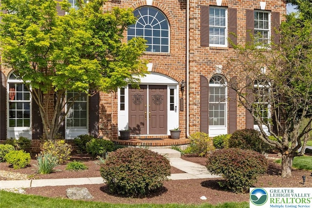 property entrance with brick siding