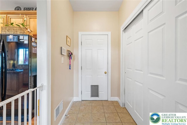 interior space featuring visible vents, baseboards, and light tile patterned floors