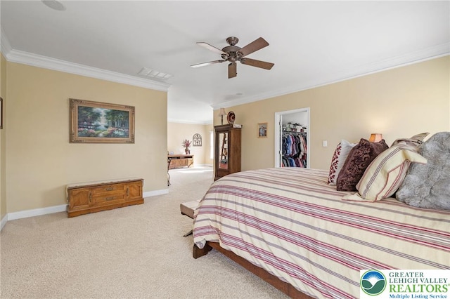carpeted bedroom featuring crown molding, baseboards, a spacious closet, and a closet