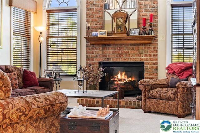 living area with carpet floors and a brick fireplace