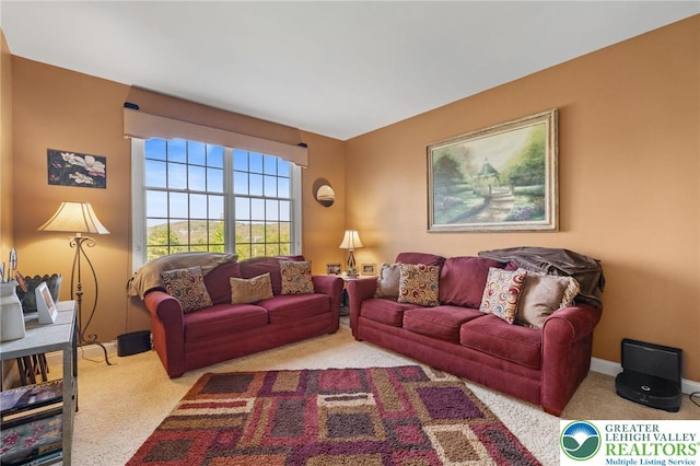 carpeted living room with baseboards