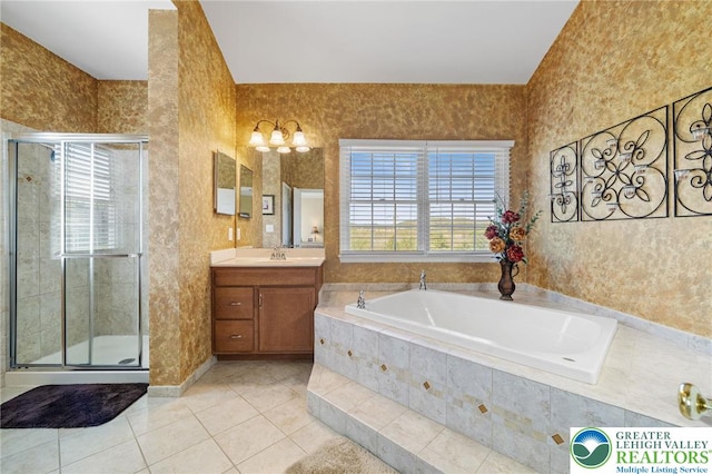 full bathroom featuring vanity, tile patterned flooring, a bath, a shower stall, and a notable chandelier