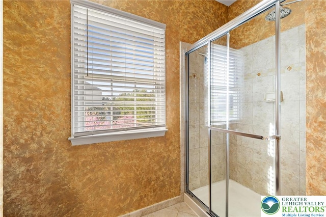 bathroom with tile patterned flooring and a stall shower