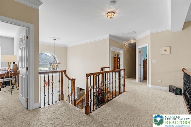 hall featuring baseboards, an upstairs landing, an inviting chandelier, ornamental molding, and carpet flooring