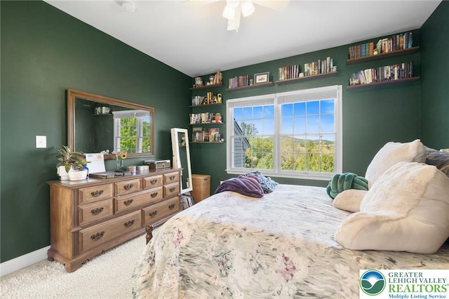 bedroom with baseboards, a ceiling fan, and carpet flooring