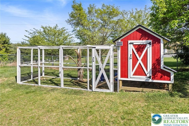 view of poultry coop with fence and a yard