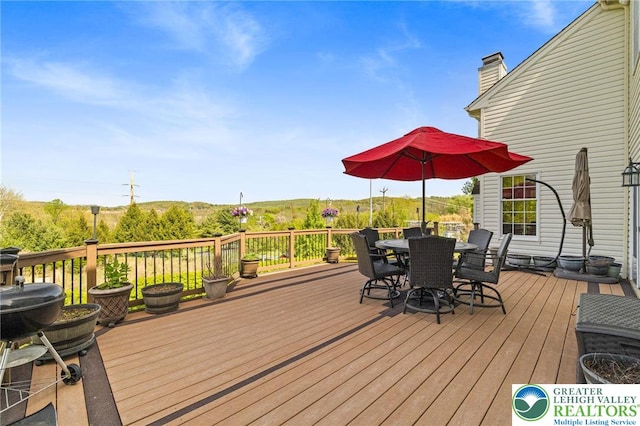 wooden deck with outdoor dining area