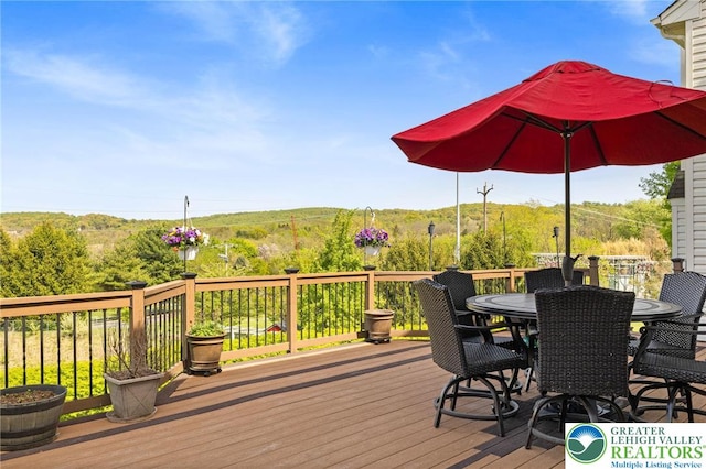 wooden terrace featuring outdoor dining area