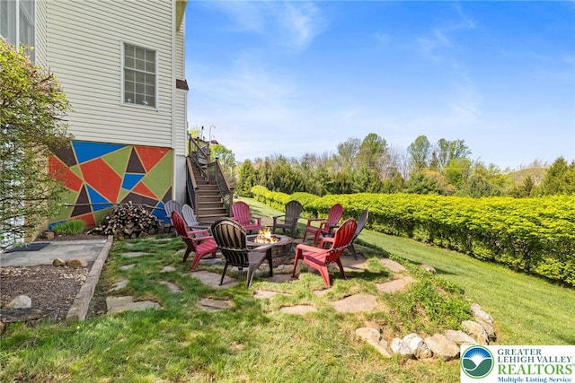view of yard featuring a fire pit and stairway