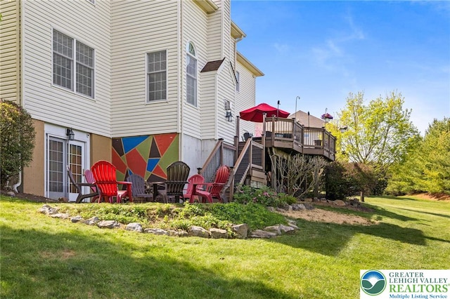 exterior space with a wooden deck, a yard, and stairway