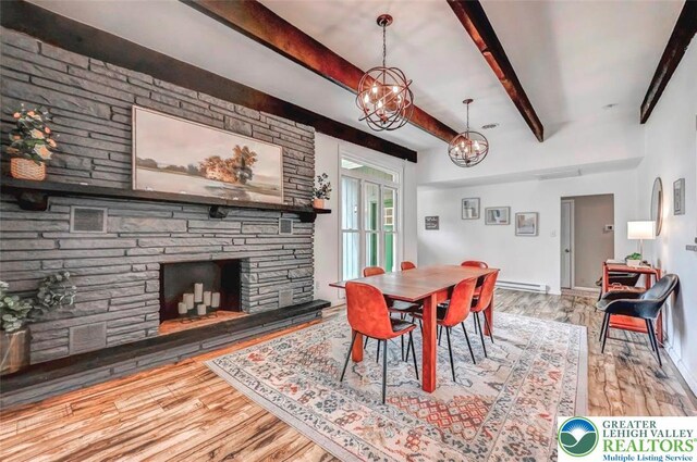 134 Altemose Rd, Tobyhanna Twp, PA 18347 - dining room with a fireplace, beam ceiling, wood finished floors, a baseboard heating unit, and an inviting chandelier