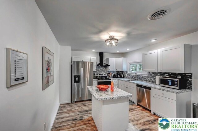 134 Altemose Rd, Tobyhanna Twp, PA 18347 - kitchen with visible vents, wall chimney range hood, a sink, light wood-style flooring, and stainless steel appliances