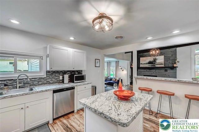 134 Altemose Rd, Tobyhanna Twp, PA 18347 - kitchen with a sink, light wood finished floors, appliances with stainless steel finishes, and backsplash