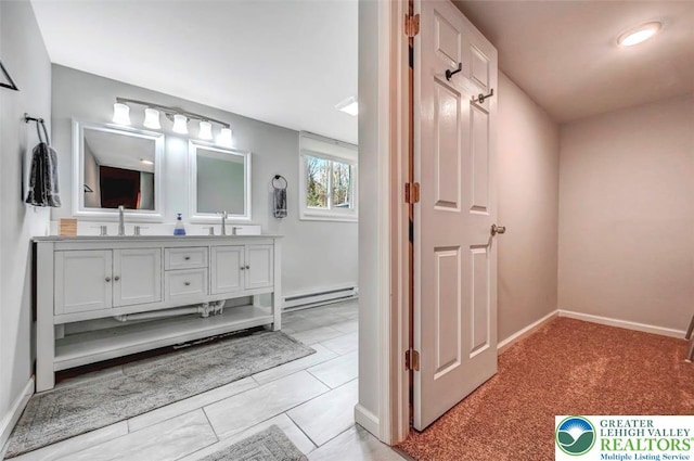 134 Altemose Rd, Tobyhanna Twp, PA 18347 - bathroom featuring double vanity, baseboards, a baseboard heating unit, and a sink