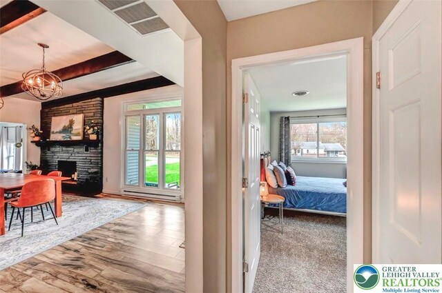 134 Altemose Rd, Tobyhanna Twp, PA 18347 - hallway with visible vents, wood finished floors, beam ceiling, a baseboard radiator, and a chandelier